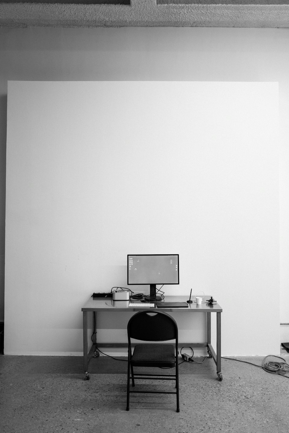 Modern computer setup on a stainless steel rolling table.